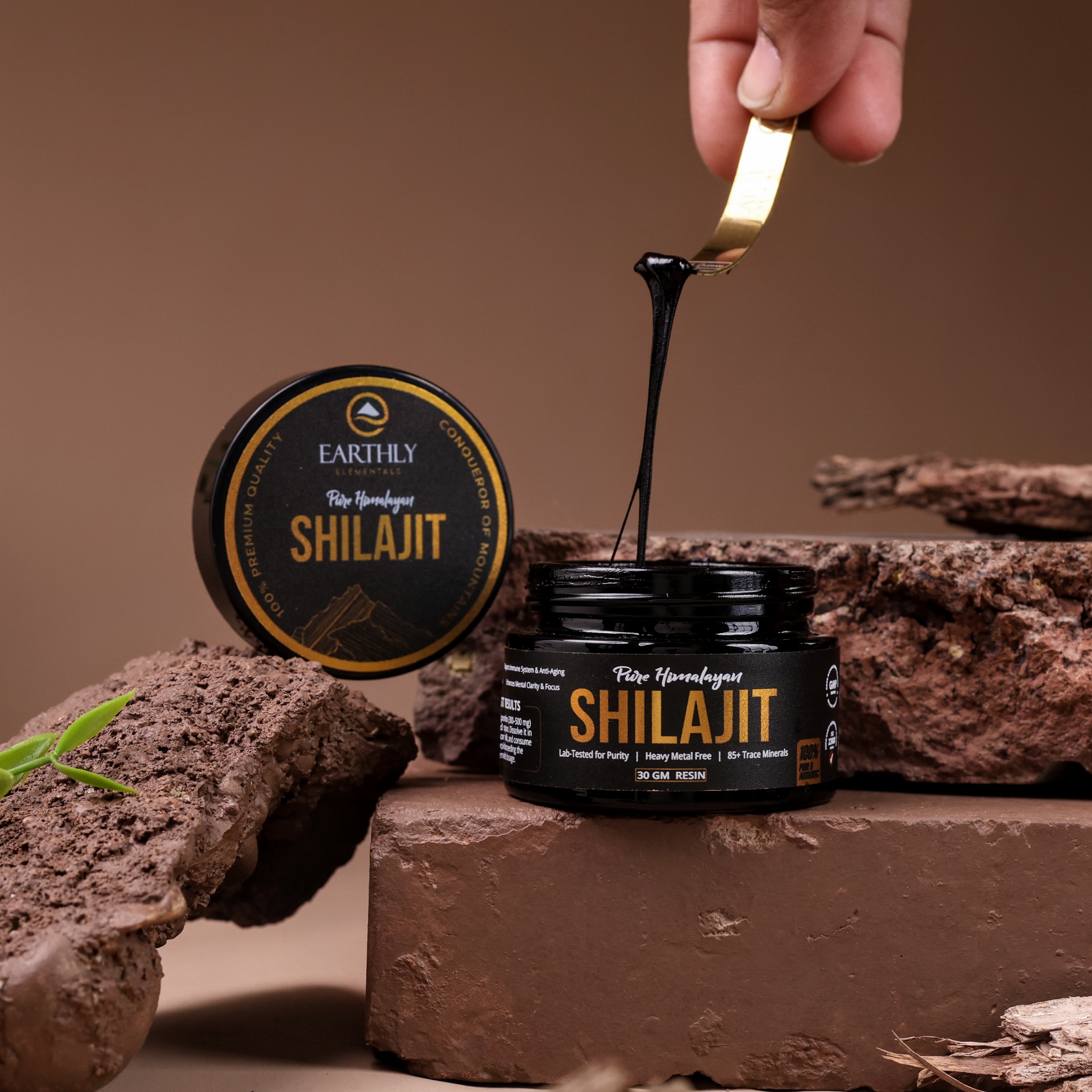 Premium shilajit resin jar with dripping extract and natural rock background